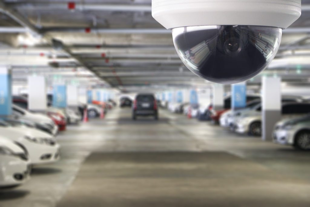 Outdoor parking garage with dome camera installed.